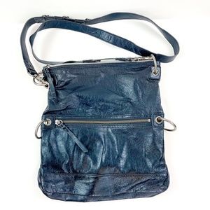 The Sak Black Leather Crossbody Bag with Metal Ring Accents